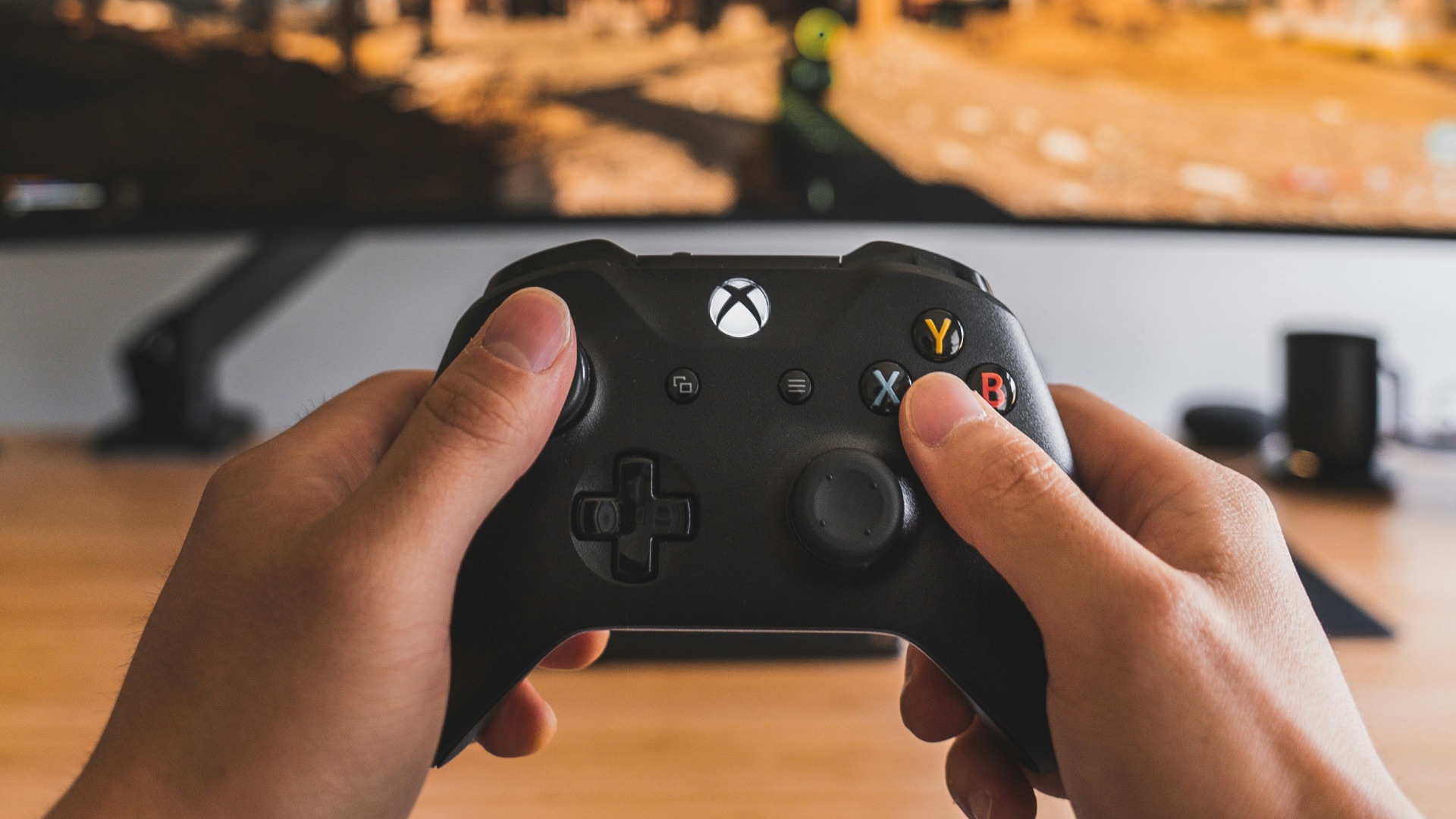 person holding black game controller