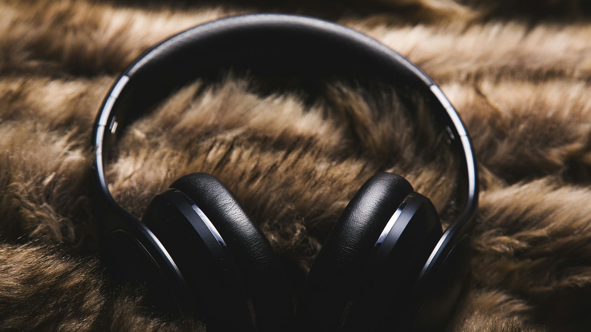 black headphones on brown textile
