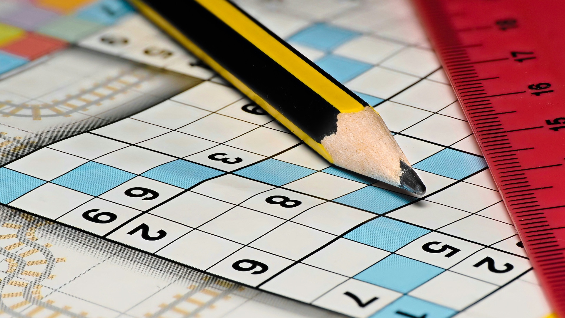 A pencil sitting on top of a piece of paper next to a ruler