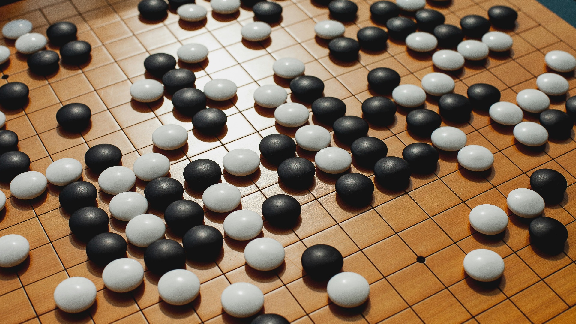 a close up of a board game with black and white balls