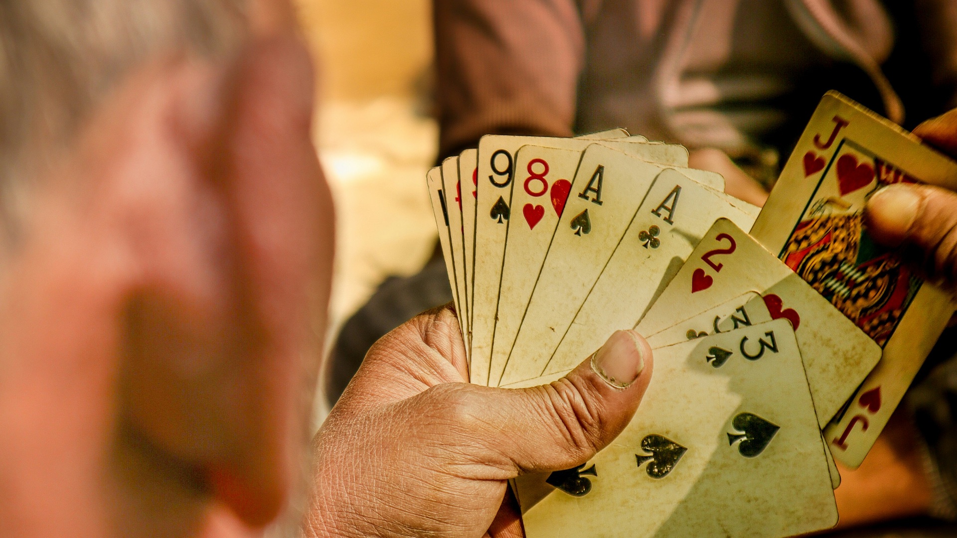 a man holding a deck of playing cards