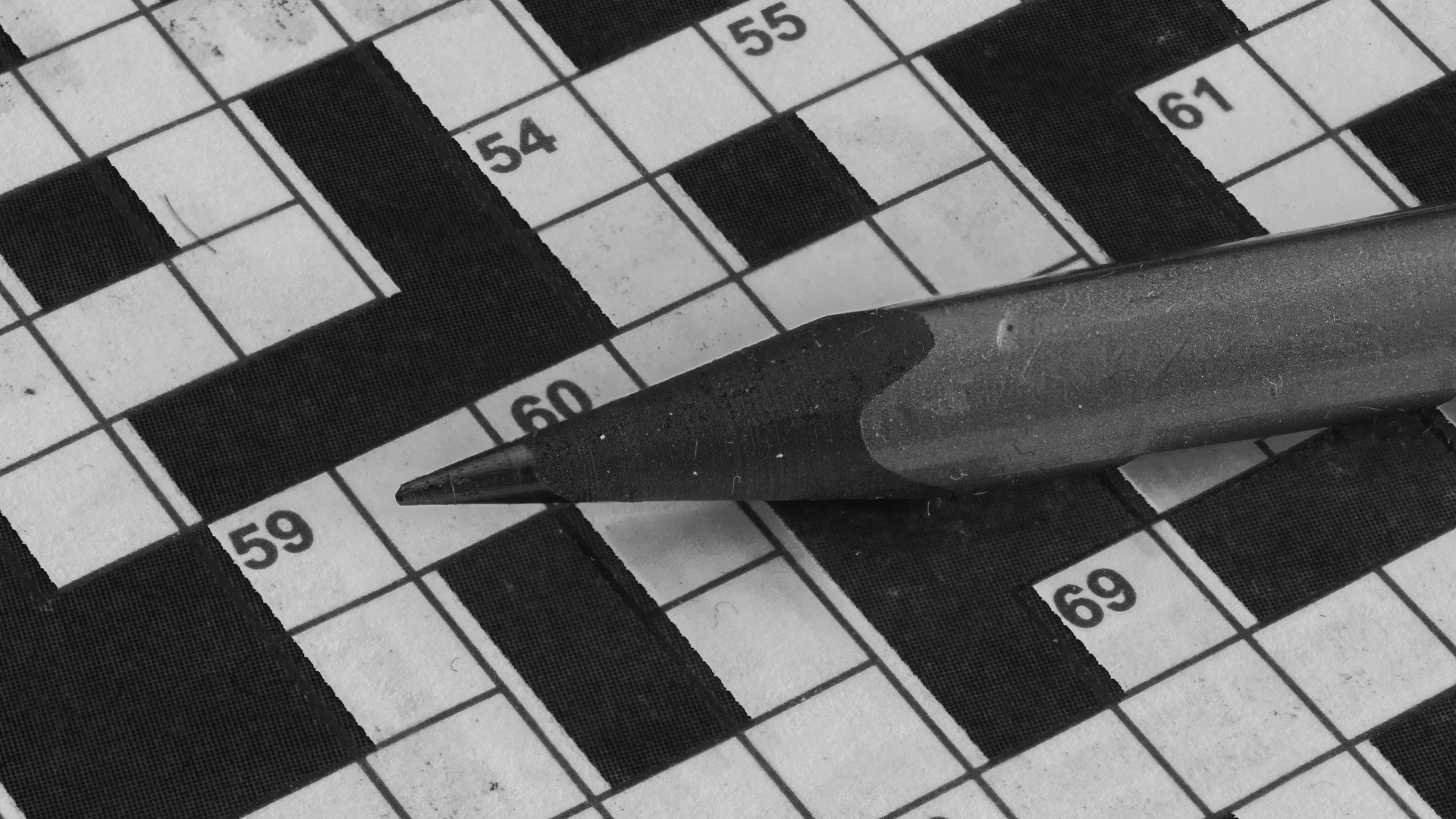 Pencil resting on a crossword puzzle