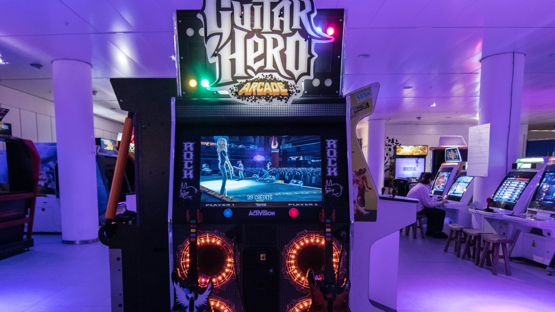 a video game machine with neon lights in a room