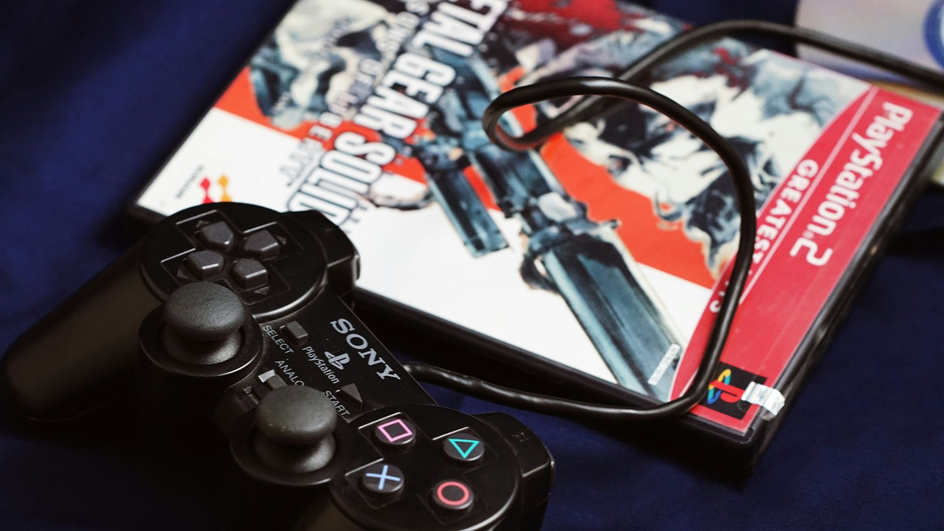 a couple of video game controllers sitting next to a dvd