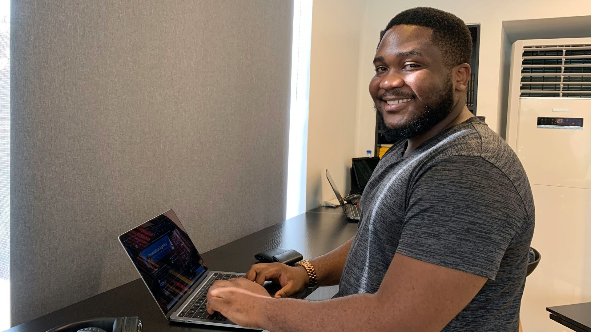 a man sitting at a desk with a laptop