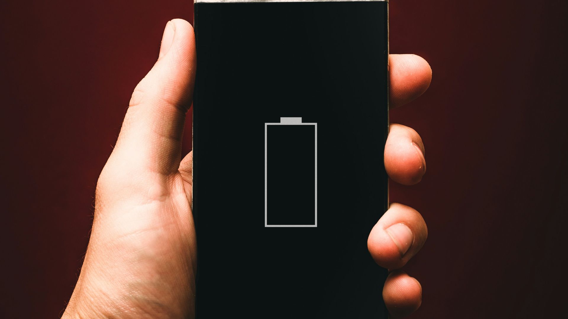 person holding low battery smartphone