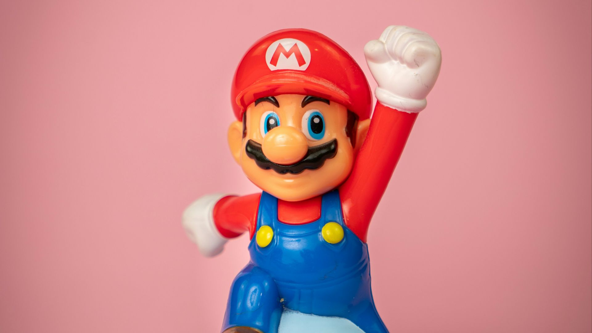 a toy figure of mario on top of a blue object
