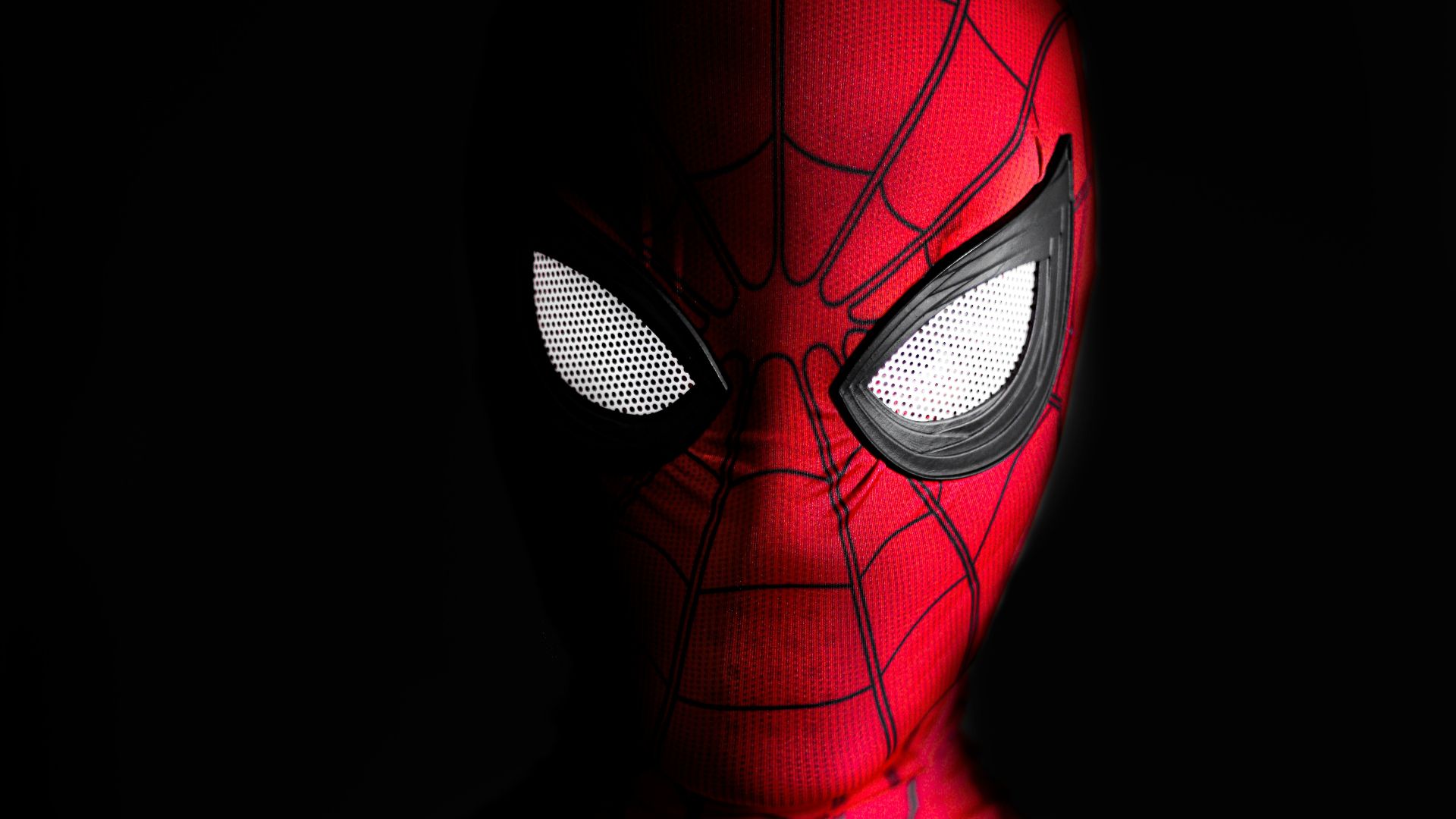 a close up of a spider man with glowing eyes