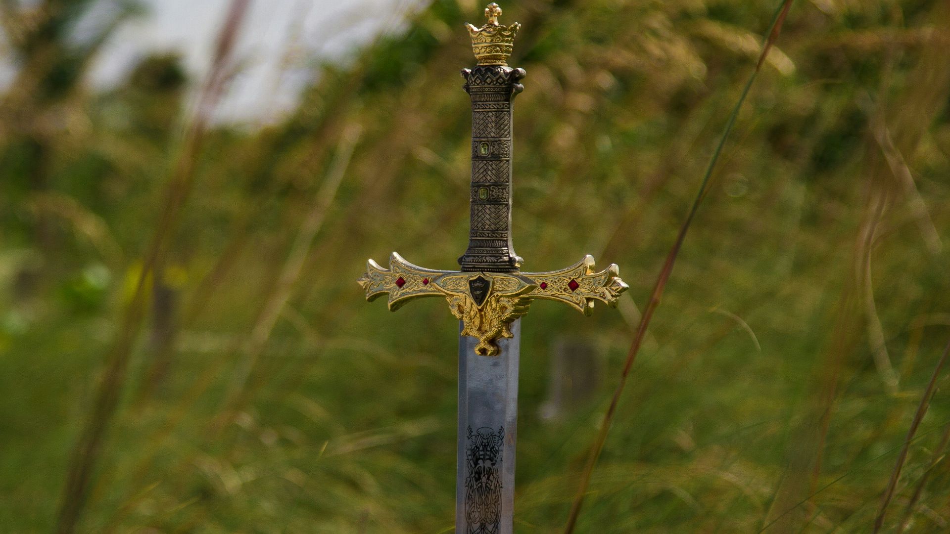 gray steel sword on ground during daytime