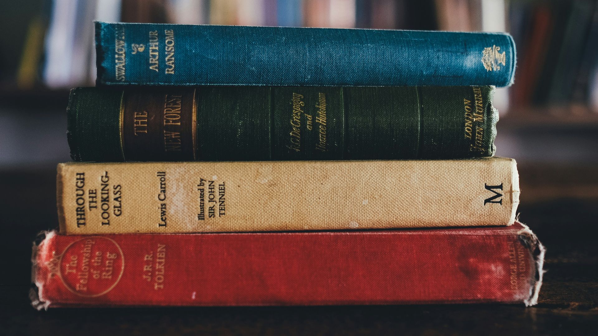 four assorted reading books on brown surface