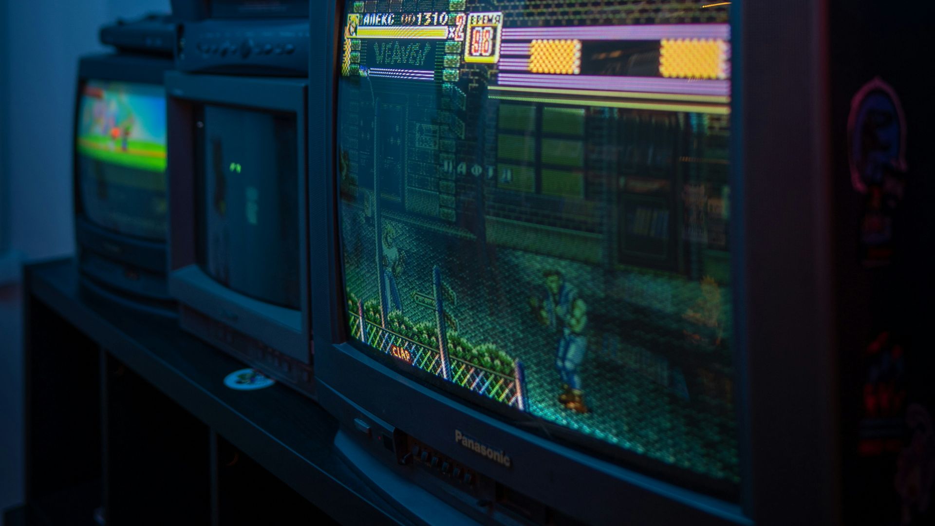 black crt tv turned on on brown wooden tv rack