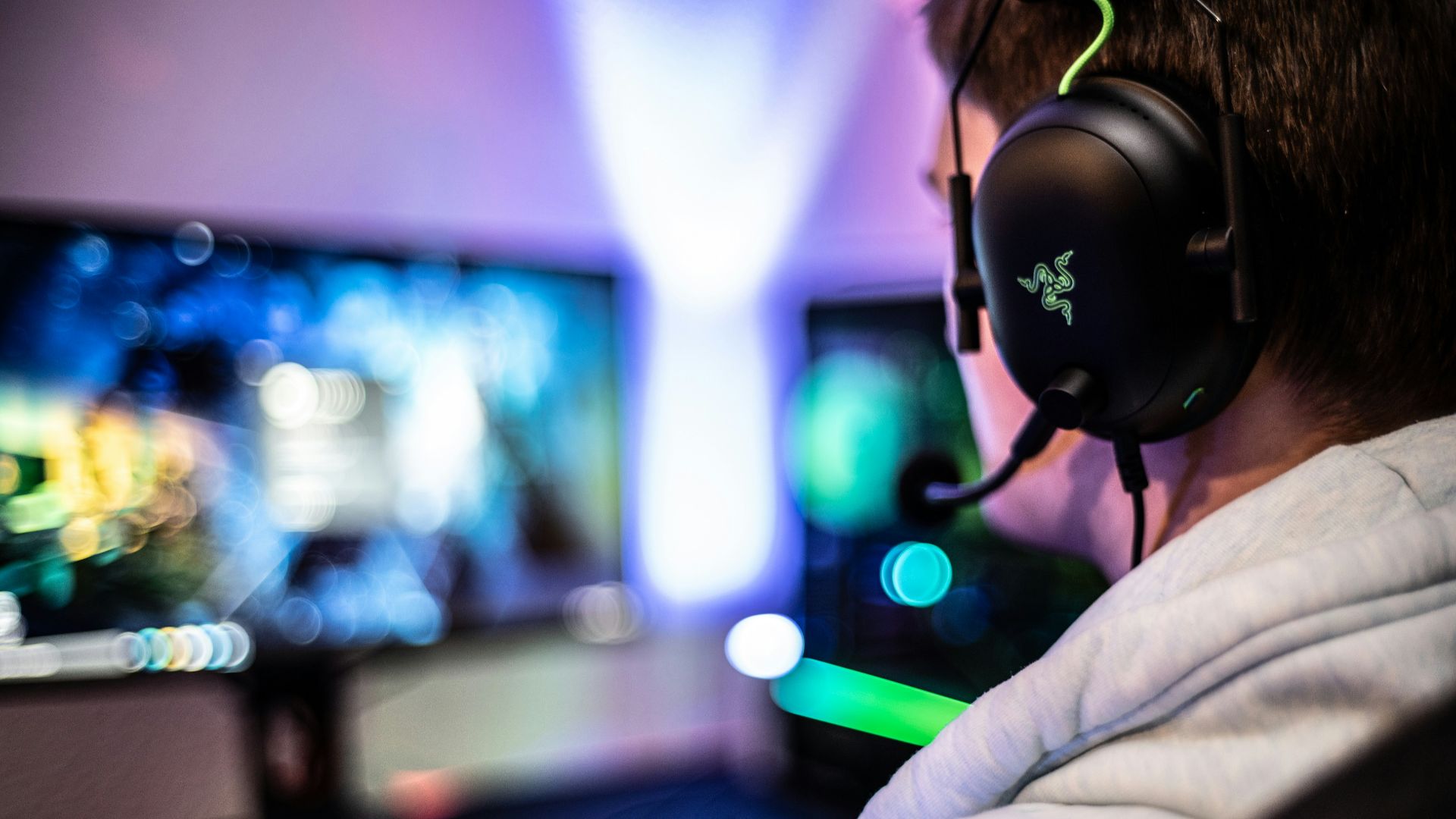 a man wearing a headset and using a computer