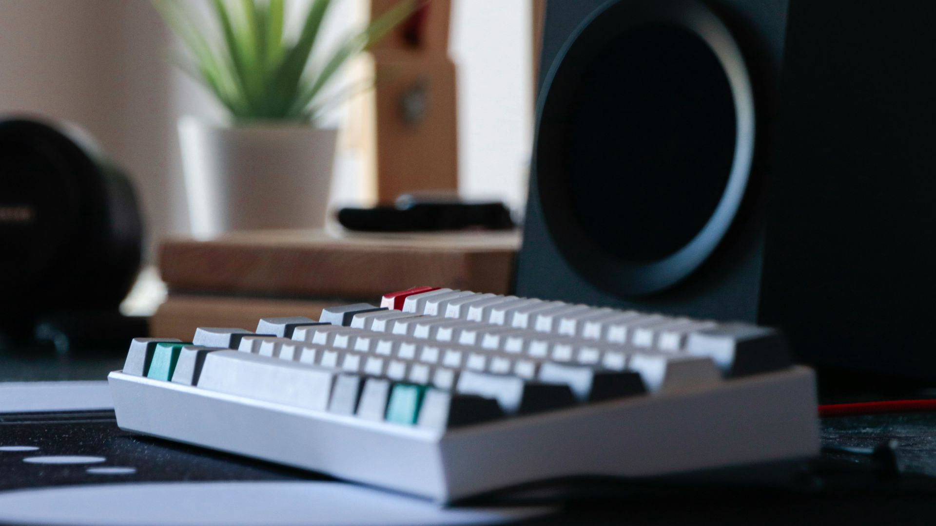 a computer keyboard sitting on top of a desk