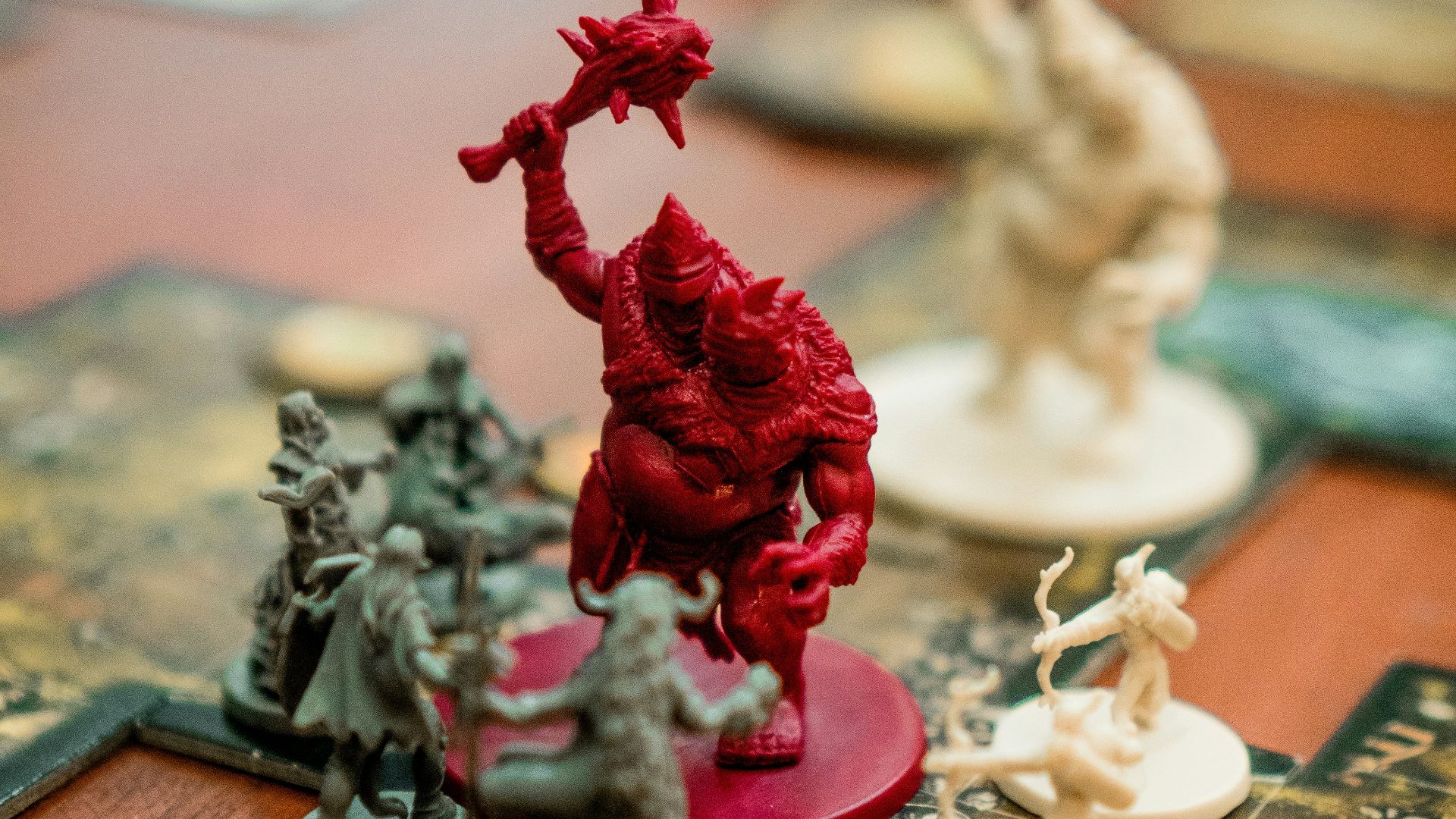 red, white, and green action figures on table