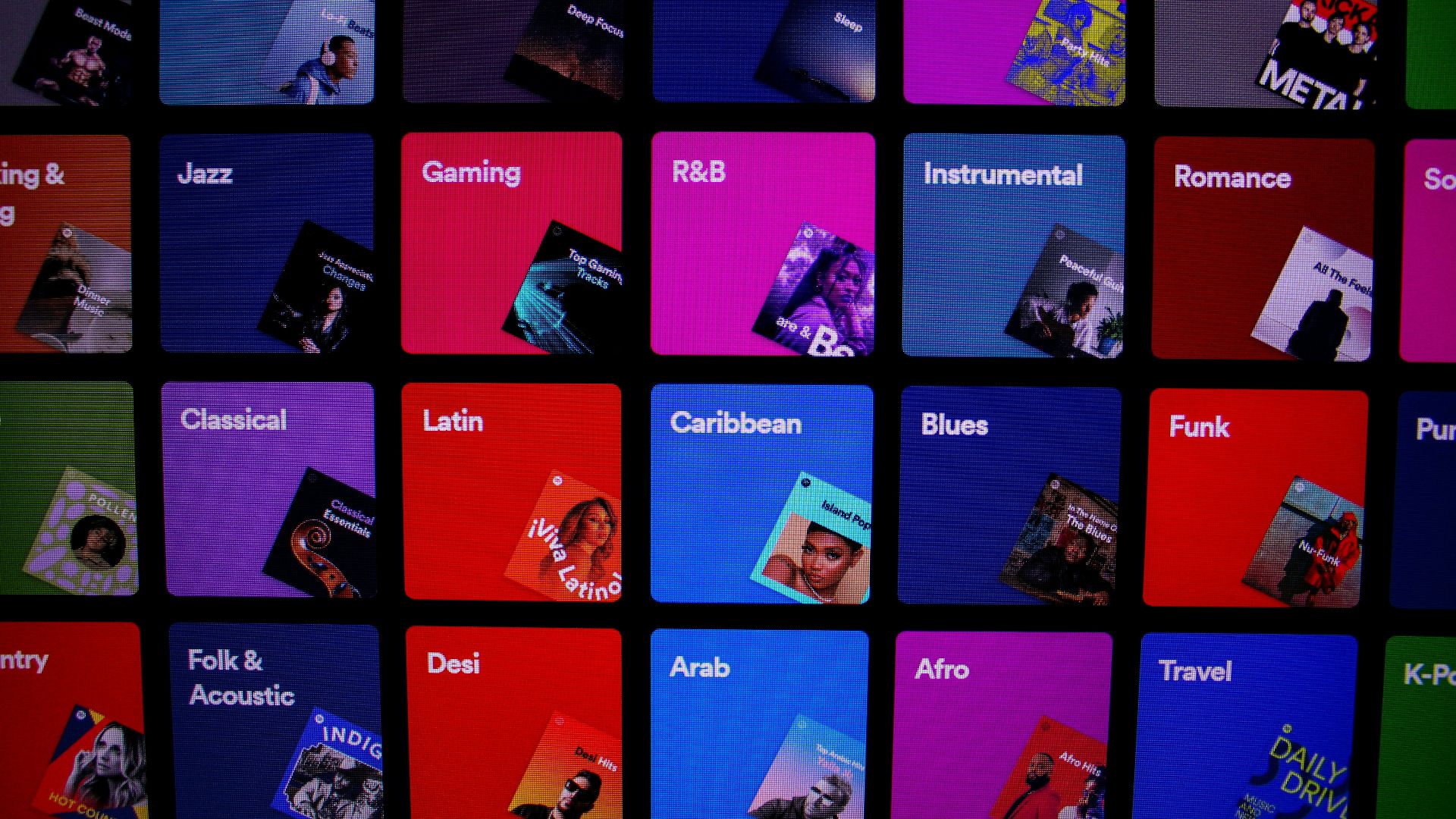 a bunch of different colored pictures on a wall