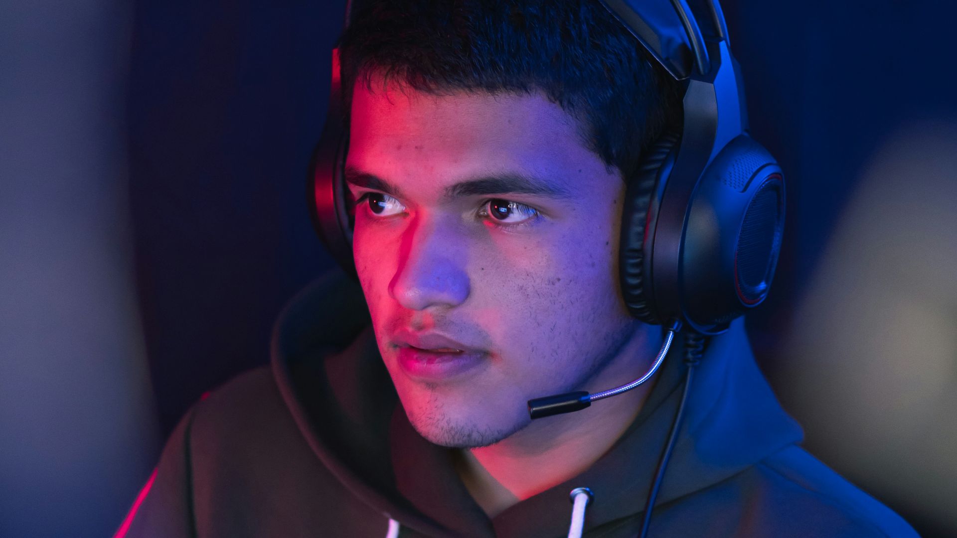 man in blue hoodie wearing black headphones