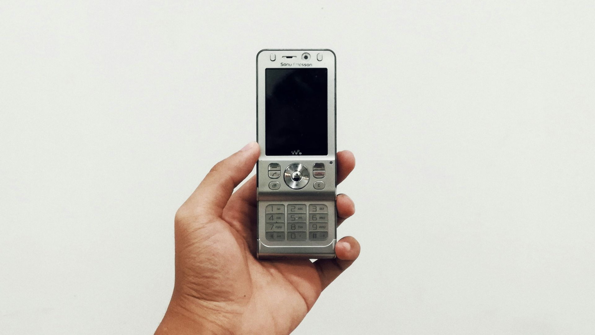 person holding gray candybar phone