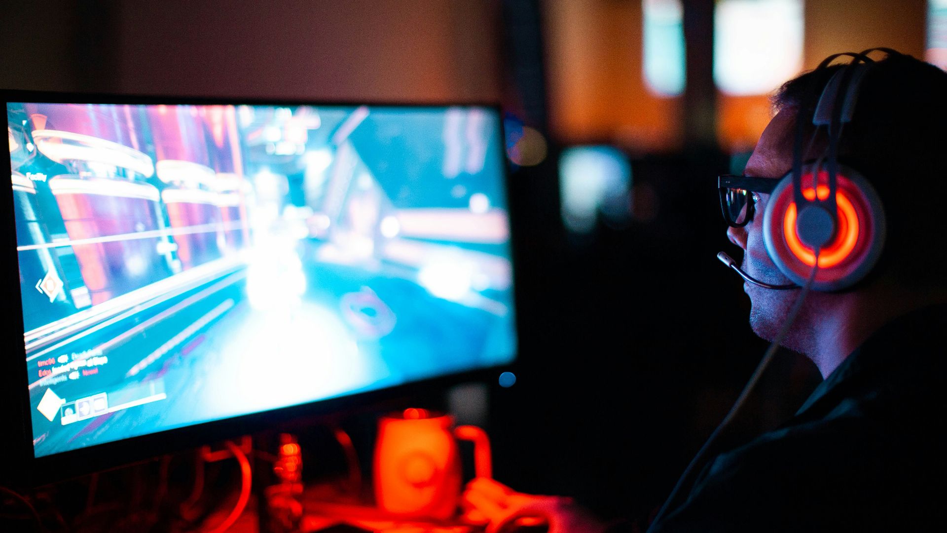 person using computer playing FPS game