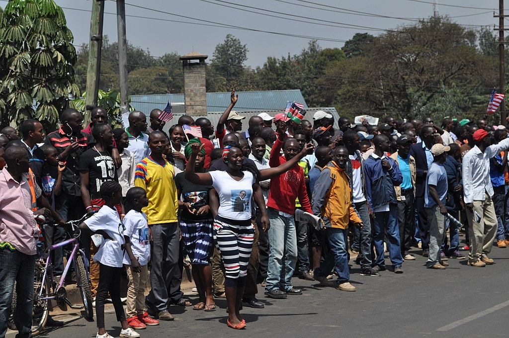 1024px-a_woman_leading_her_community_from_kibera_to_see_president_obama_at_-1539282328819.jpg