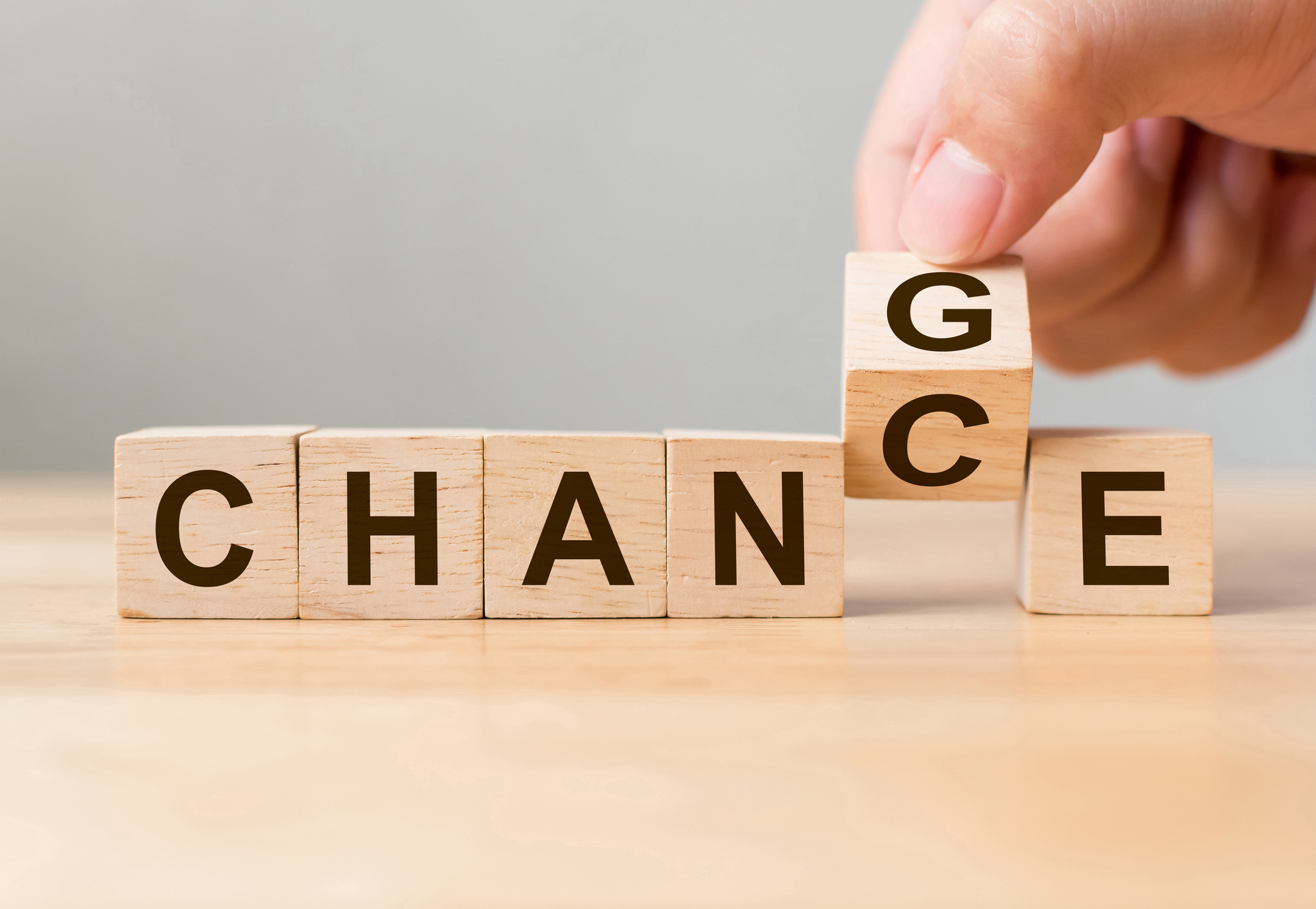 Wooden cube with word 'change' to 'chance'.