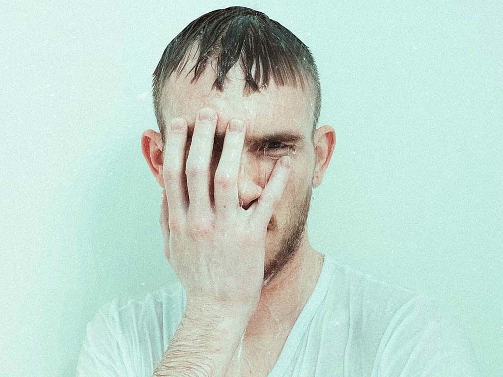 resize1_man-resting-his-right-hand-on-his-face-who-is-soaking-wet.jpg.optimal.jpg