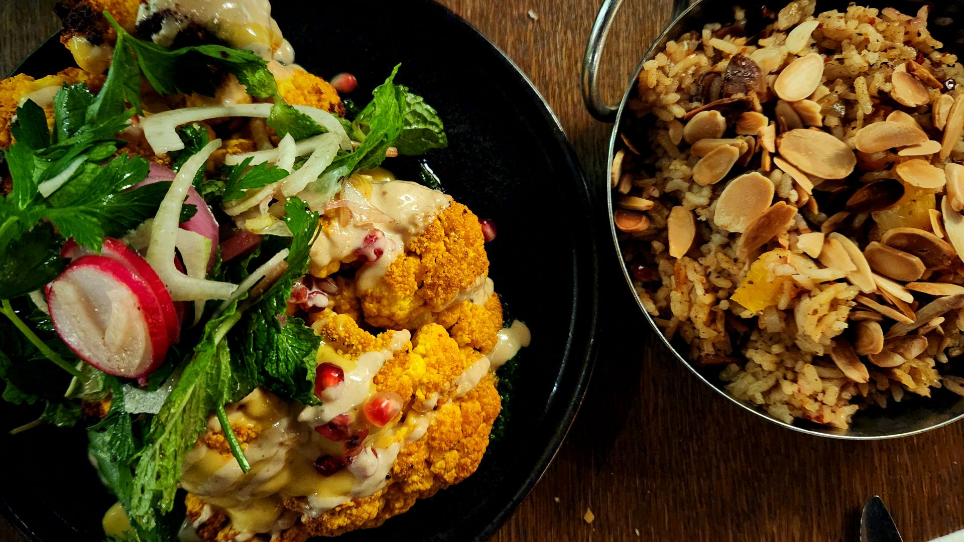 two plates of food on a wooden table