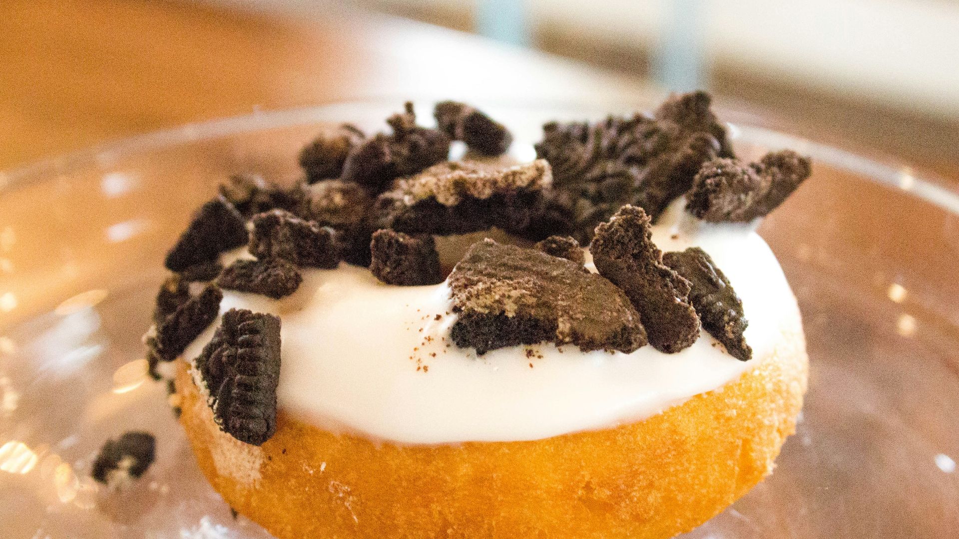 chocolate toppings donut on clear glass tray