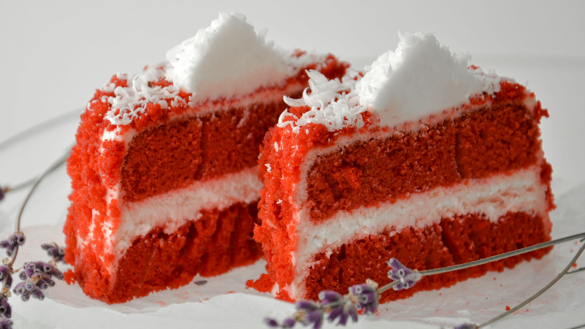 a piece of red velvet cake on a glass plate