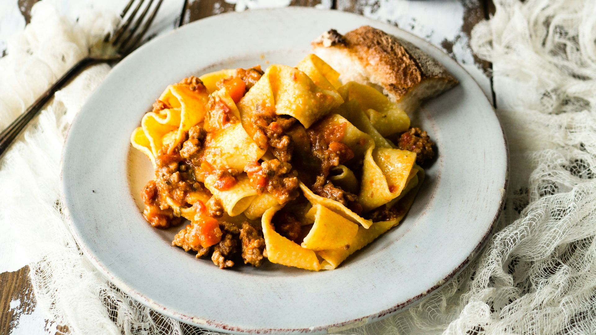 pasta on white plate near glass