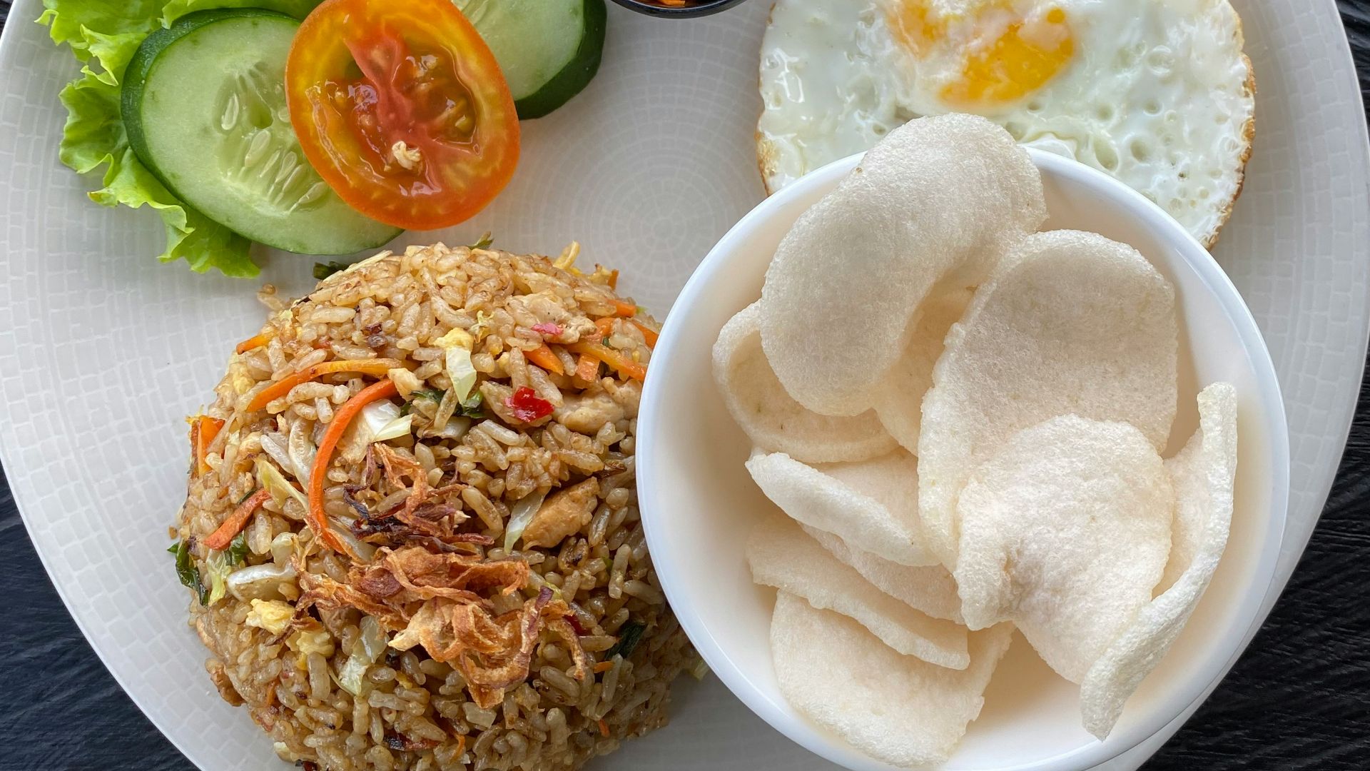 a white plate topped with rice and vegetables