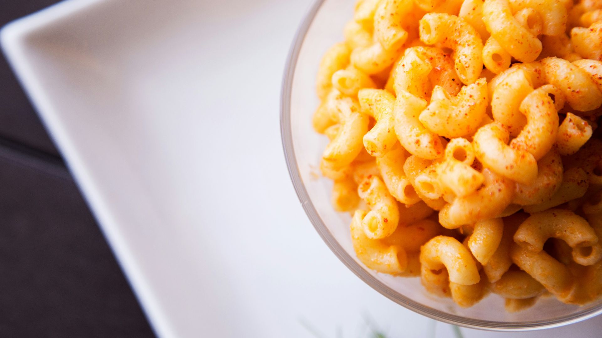 yellow pasta on clear glass bowl