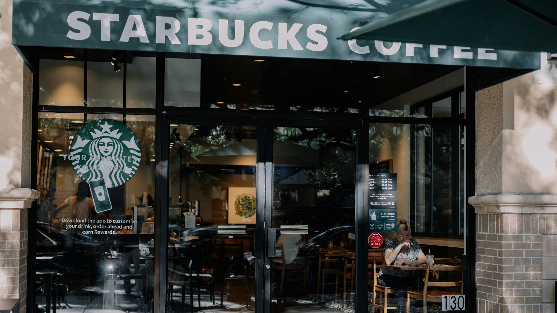 a starbucks coffee shop with a person sitting at a table