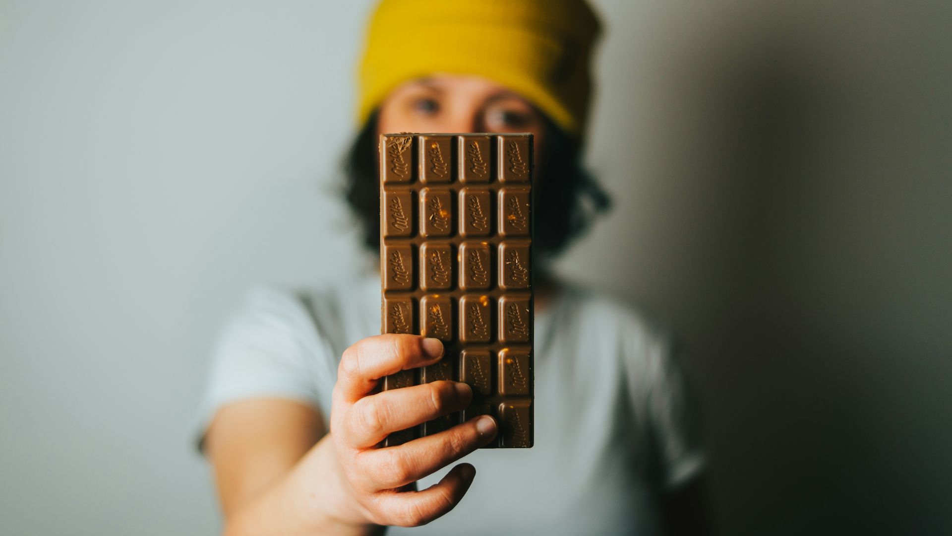 person holding brown cone with yellow cap