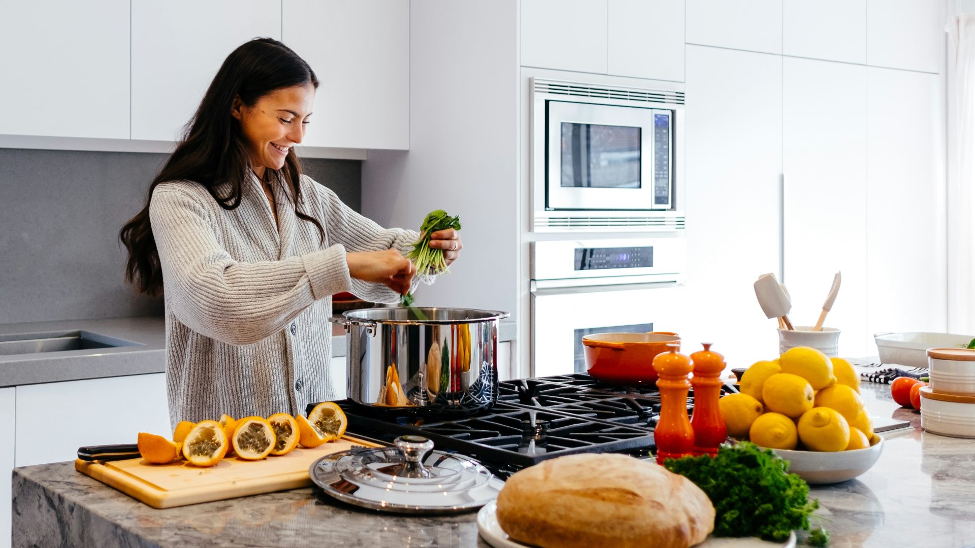 woman smiling while cooking