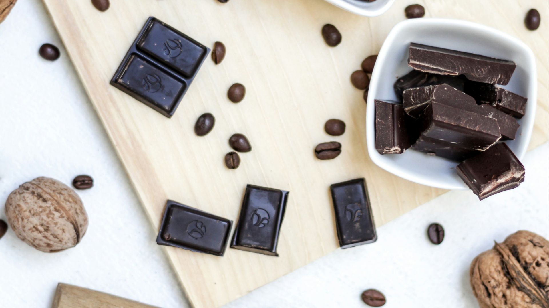 chocolate and coffee seeds on table near bowls