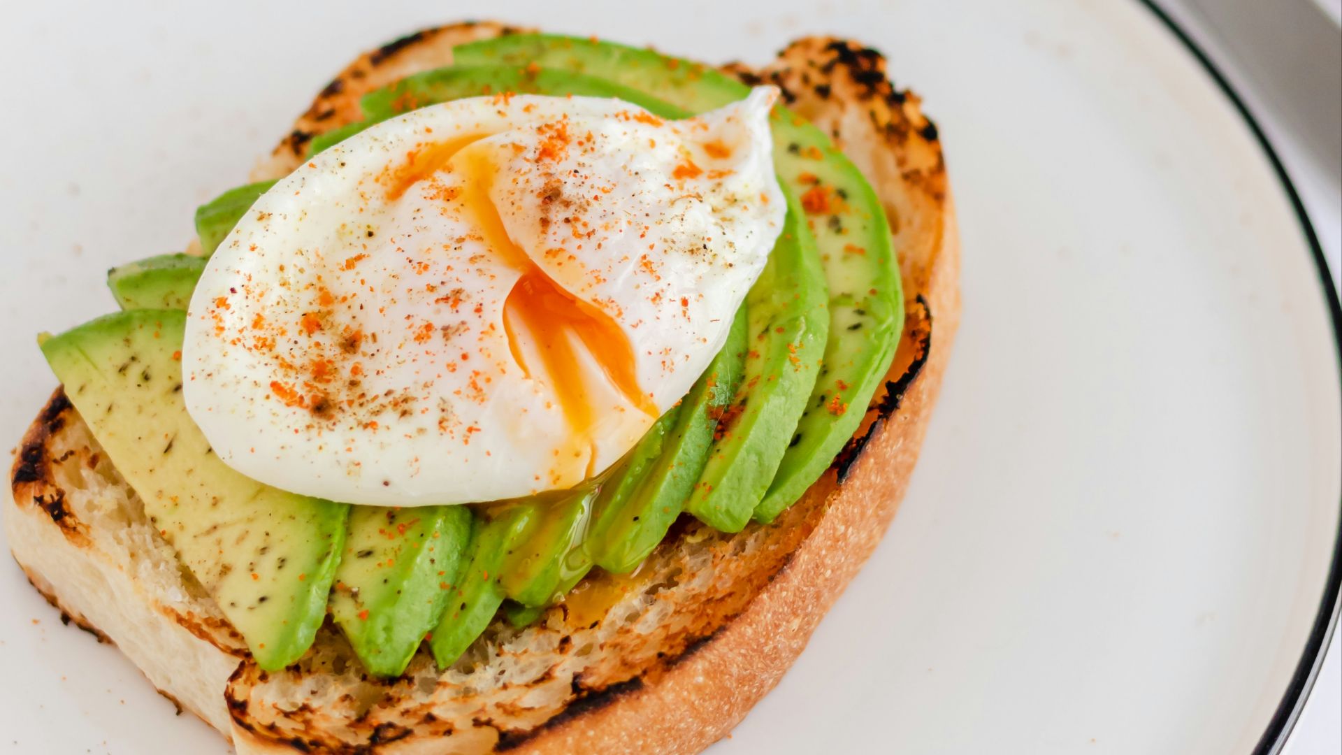 a sandwich with an egg and asparagus on it