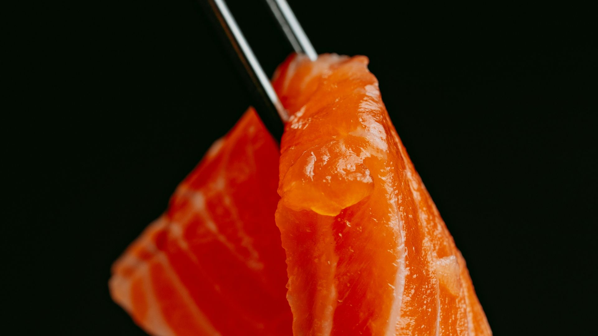 a piece of sushi with chopsticks sticking out of it
