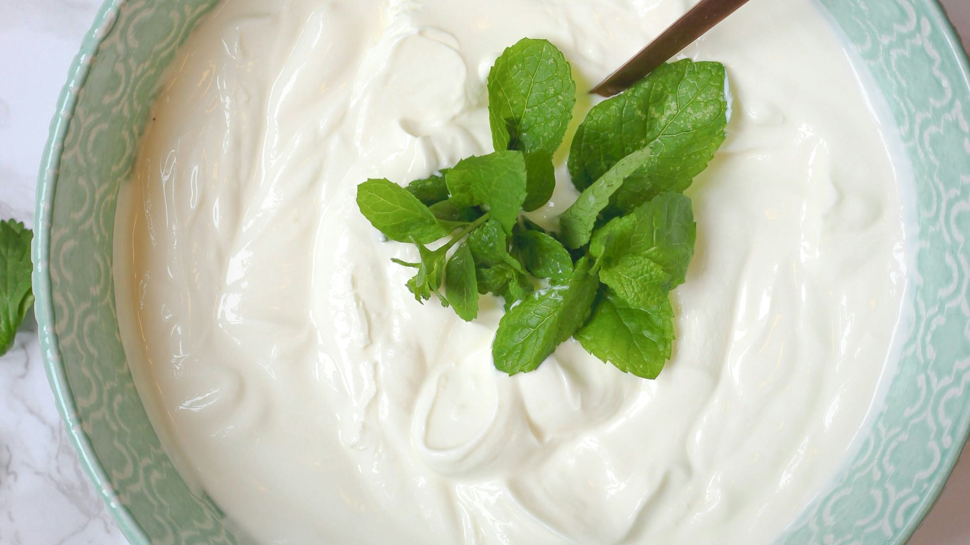 a bowl of yogurt with a spoon in it