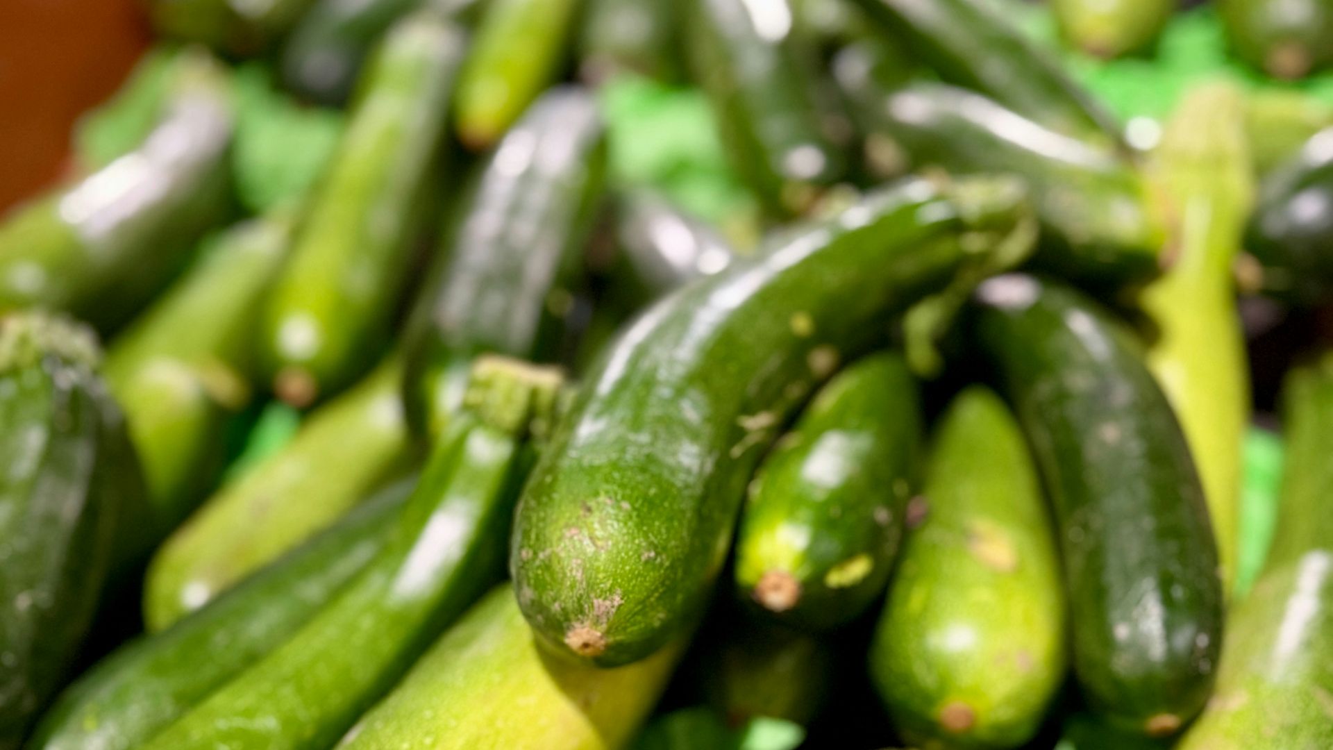 A bunch of cucumbers sitting on top of a table
