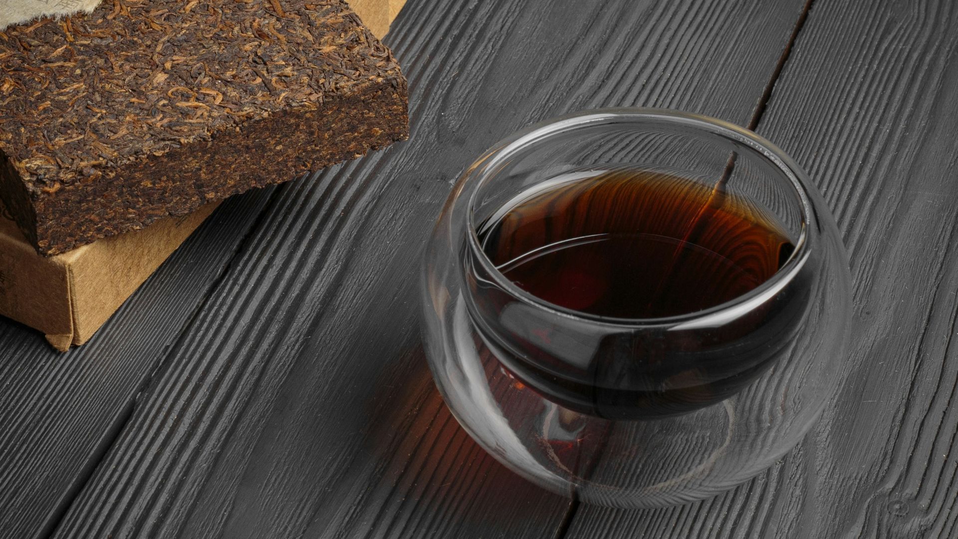 clear glass cup with brown liquid inside