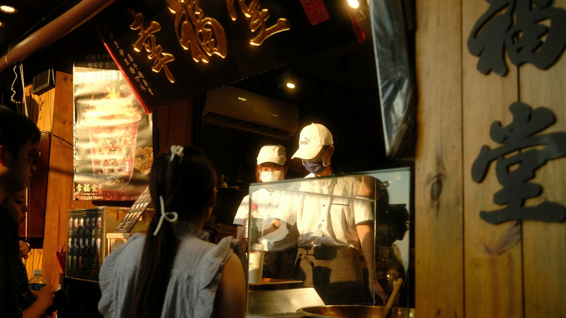A group of people standing around a restaurant kitchen