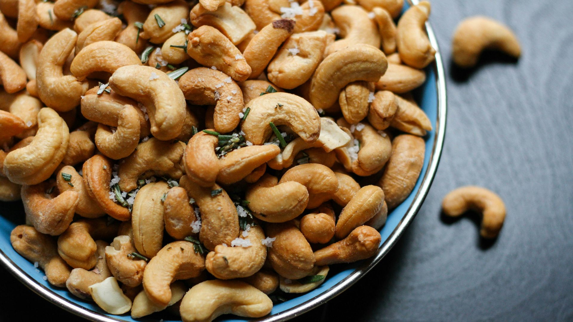 cashew nut lot on blue ceramic bowl