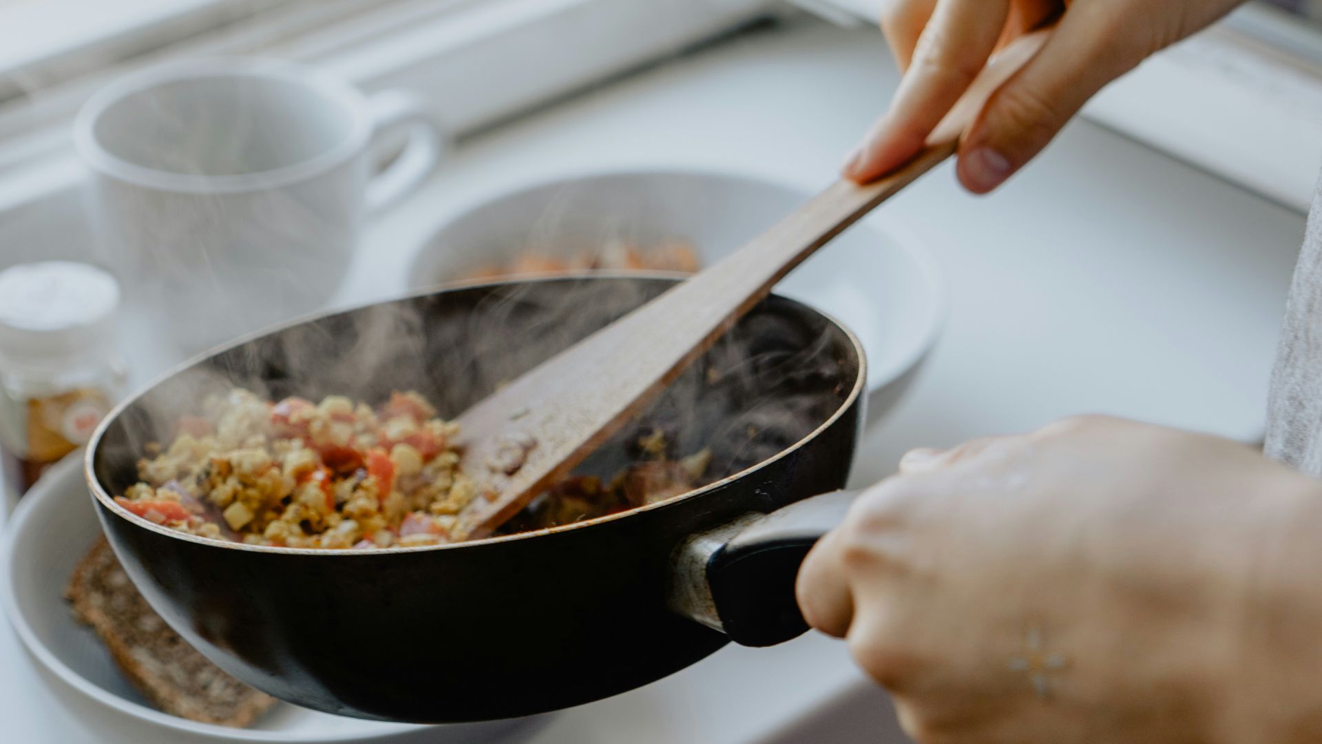 person holding black frying pan