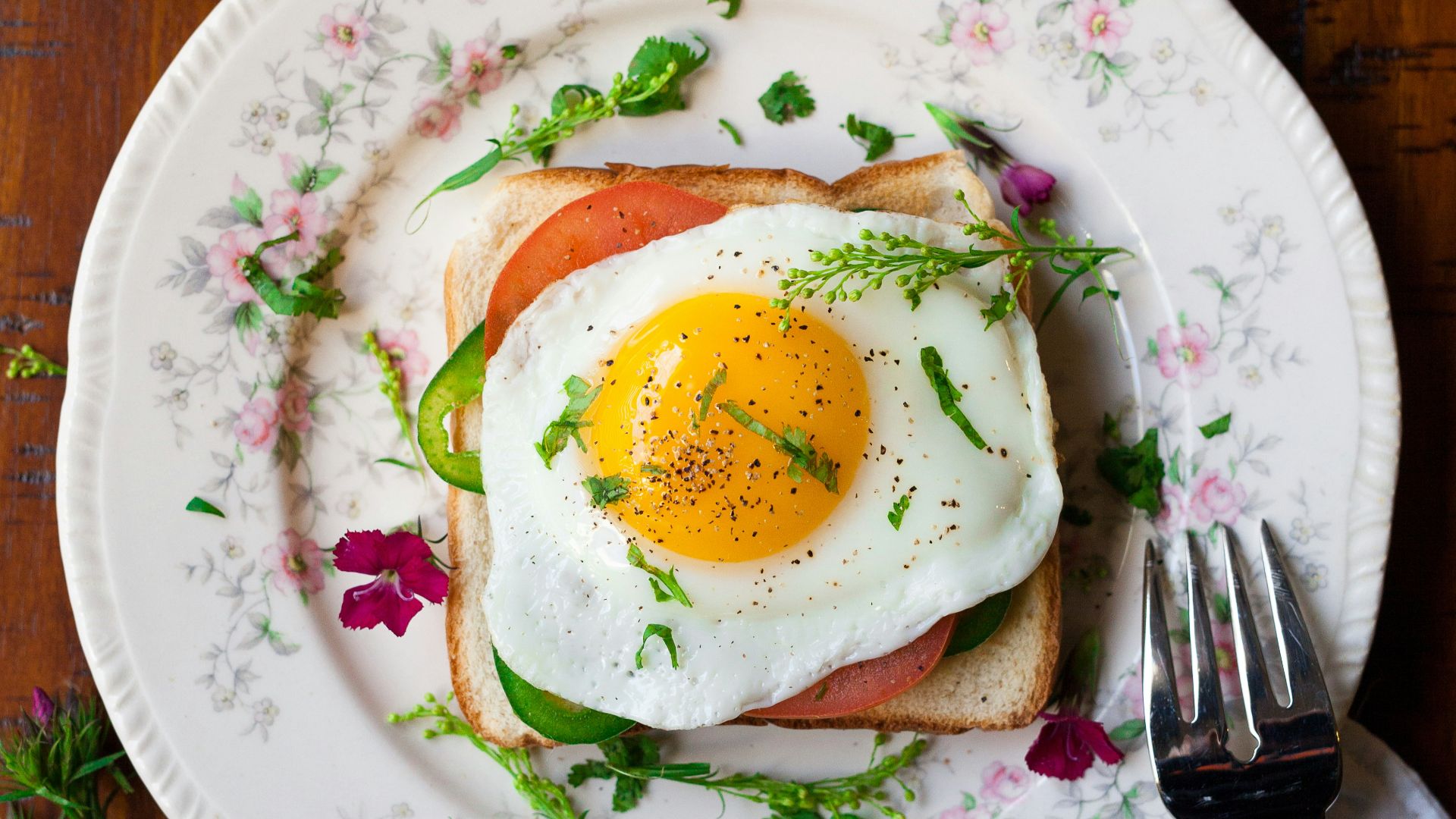 sunny-side up egg with bread beside fork