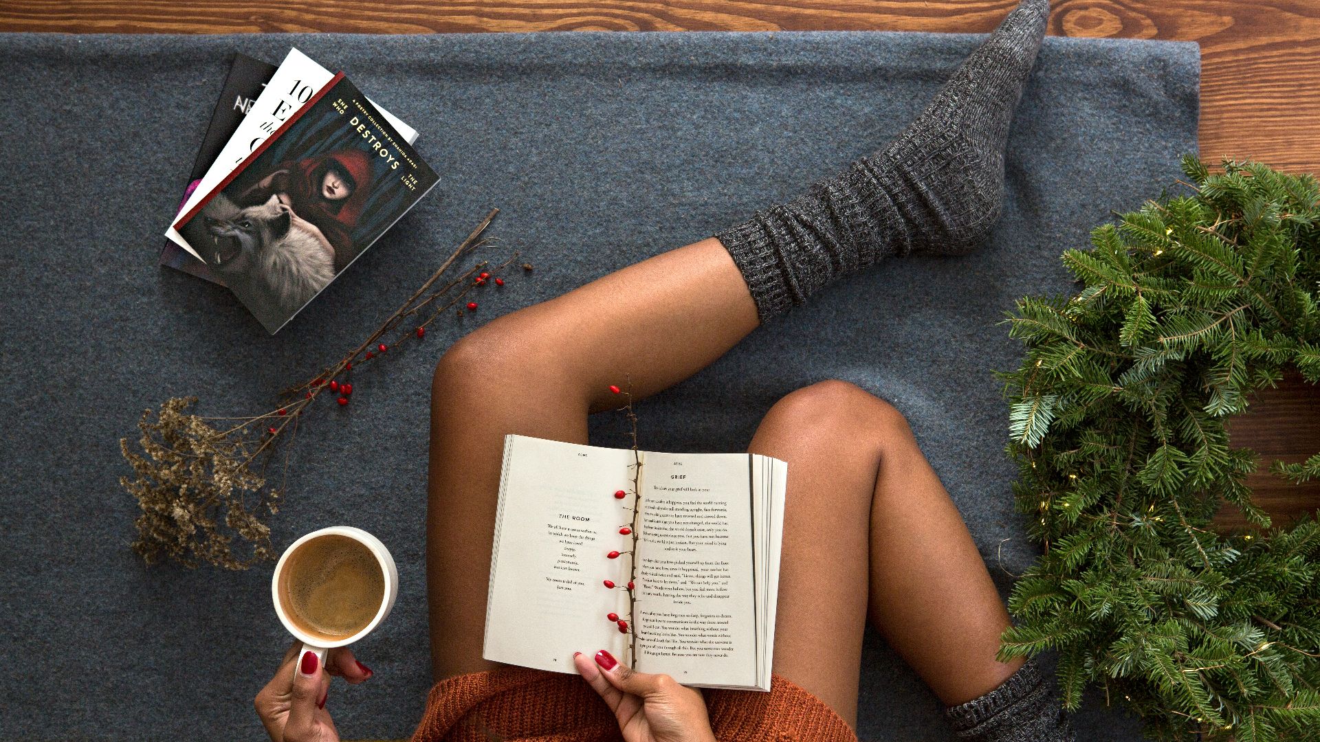 opened book on person's lap with gray socks
