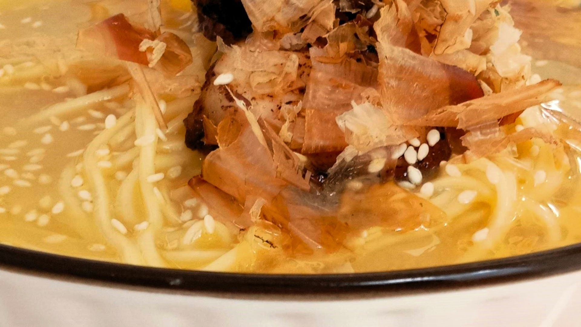 a bowl of soup with meat and noodles