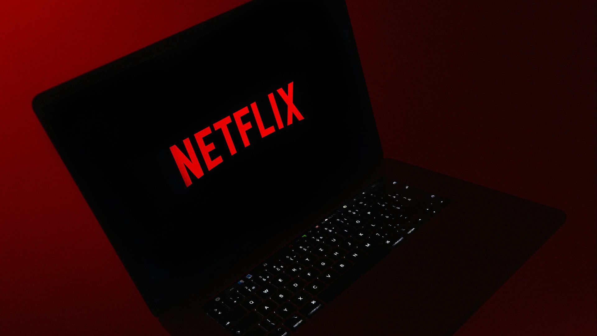 black laptop computer on red table