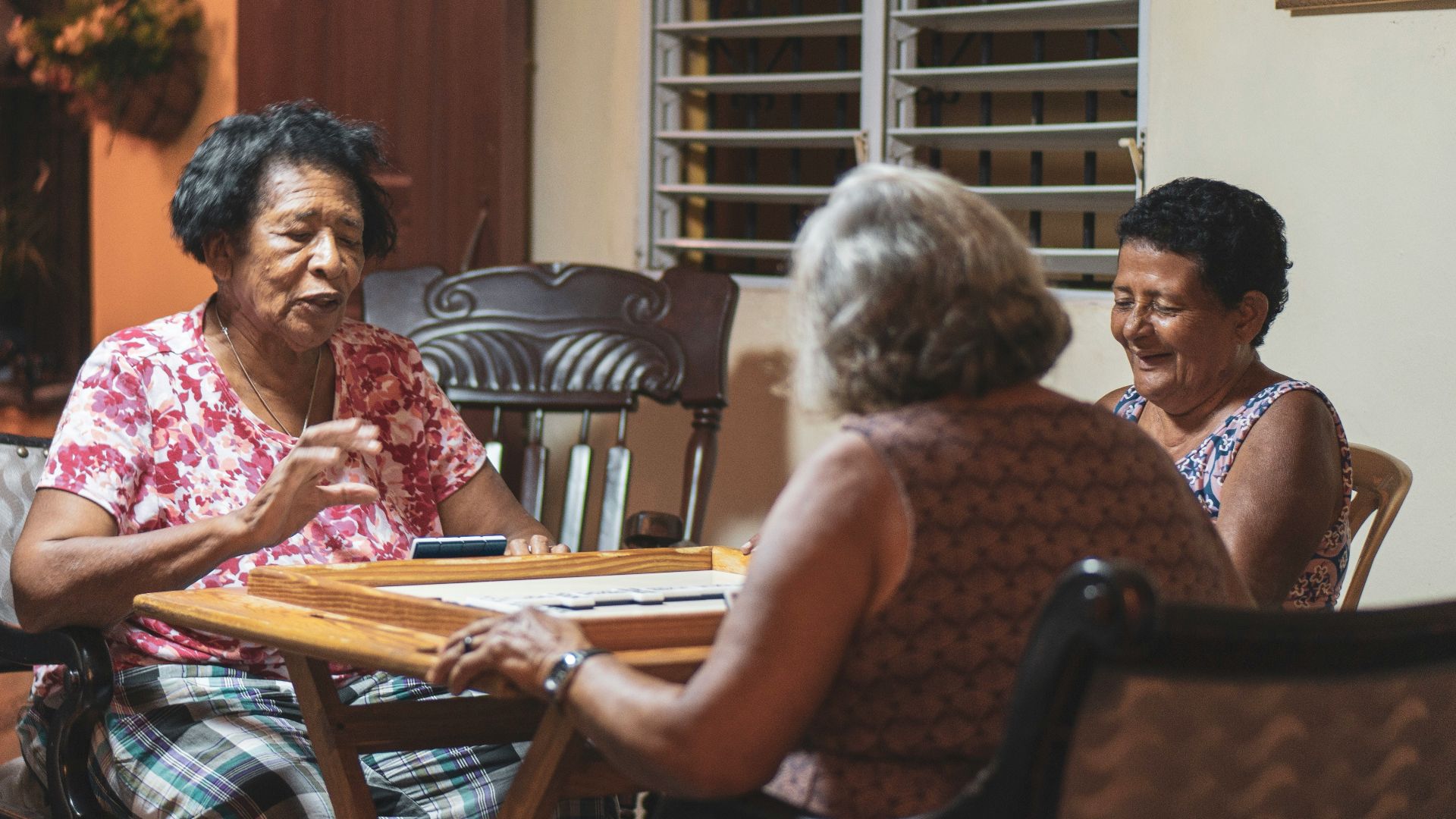 three women sitting in front of wooden table