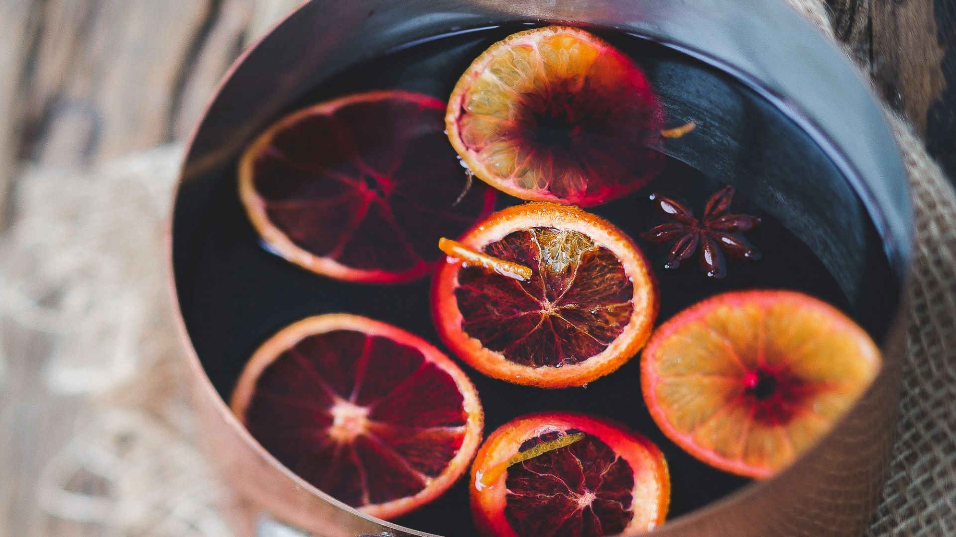close-up photography of sliced orange fruit on brown cooking pot