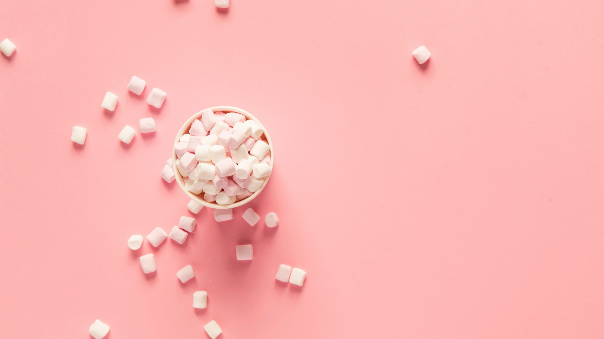 bunch of marshmallows on pink surface